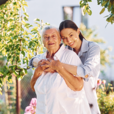 woman hugging elderly