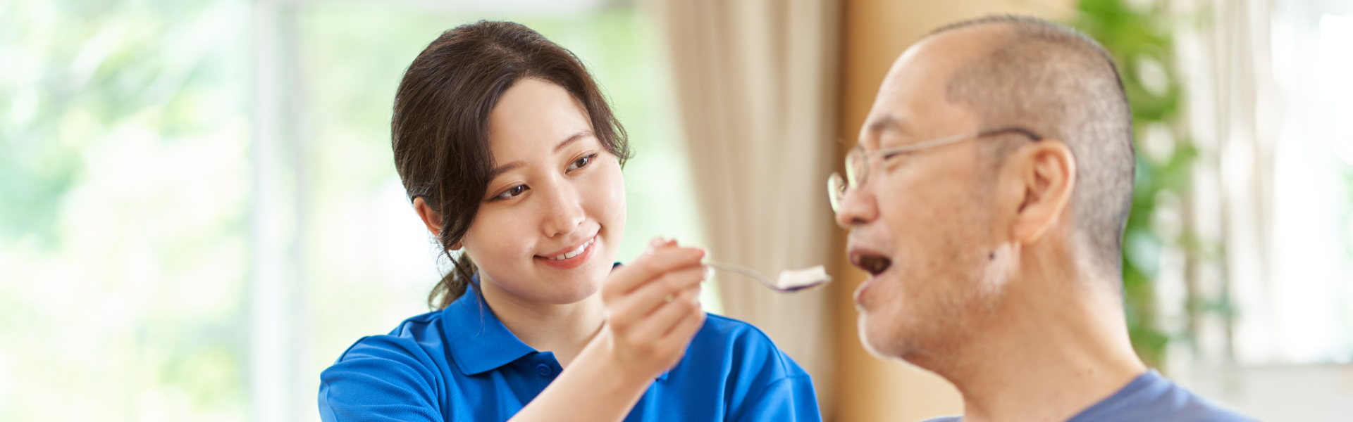 woman feeding elderly