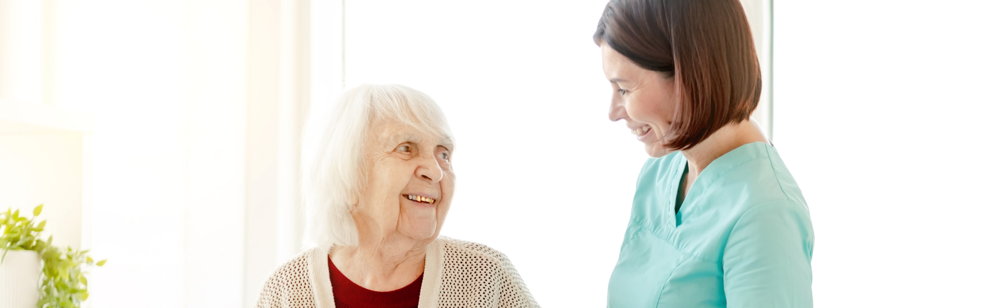woman and elderly smiling at each other